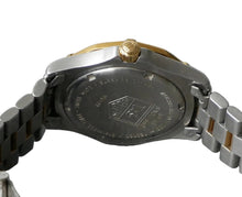 Load image into Gallery viewer, Close-up of a watch case with brand logo on a gray background
