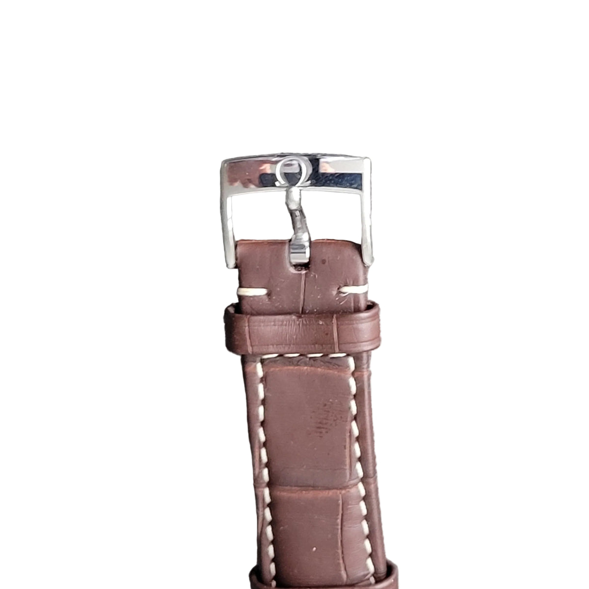 Brown leather watch strap with silver buckle on a gray background