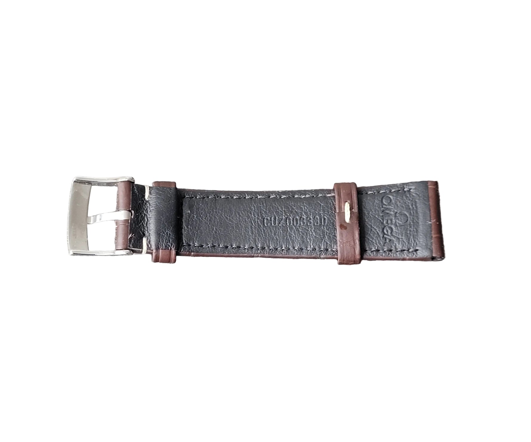 Black leather watch strap with silver buckle on a gray surface