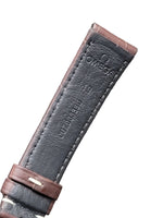 Omega watch strap with brown leather and dark gray interior on a gray background
