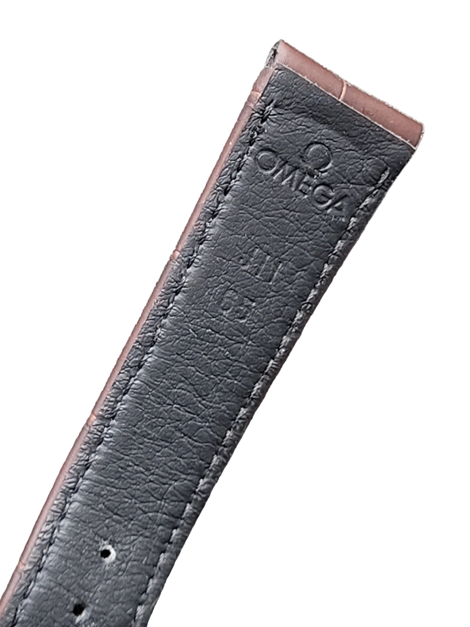 Black leather Omega watch strap on a gray surface