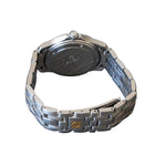 Silver watch with a detailed back cover on a gray surface