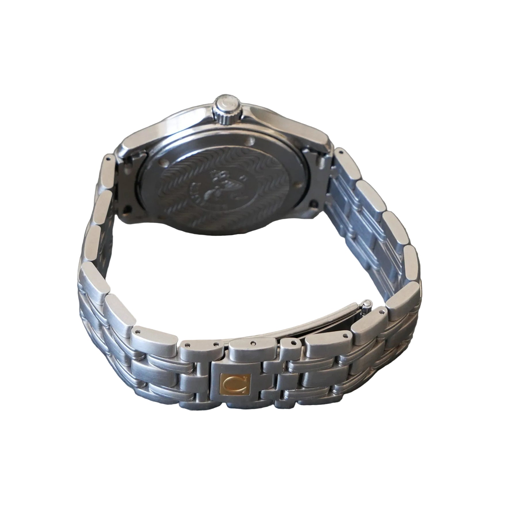Silver watch with a detailed back cover on a gray surface