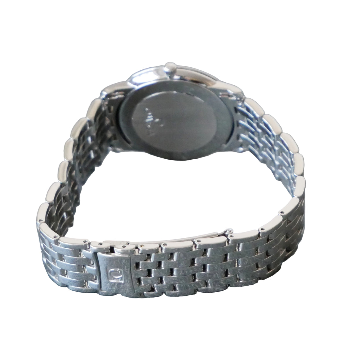 Silver watch with a metal bracelet on a gray surface