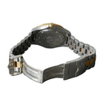 Close-up of a silver and black watch on a gray surface
