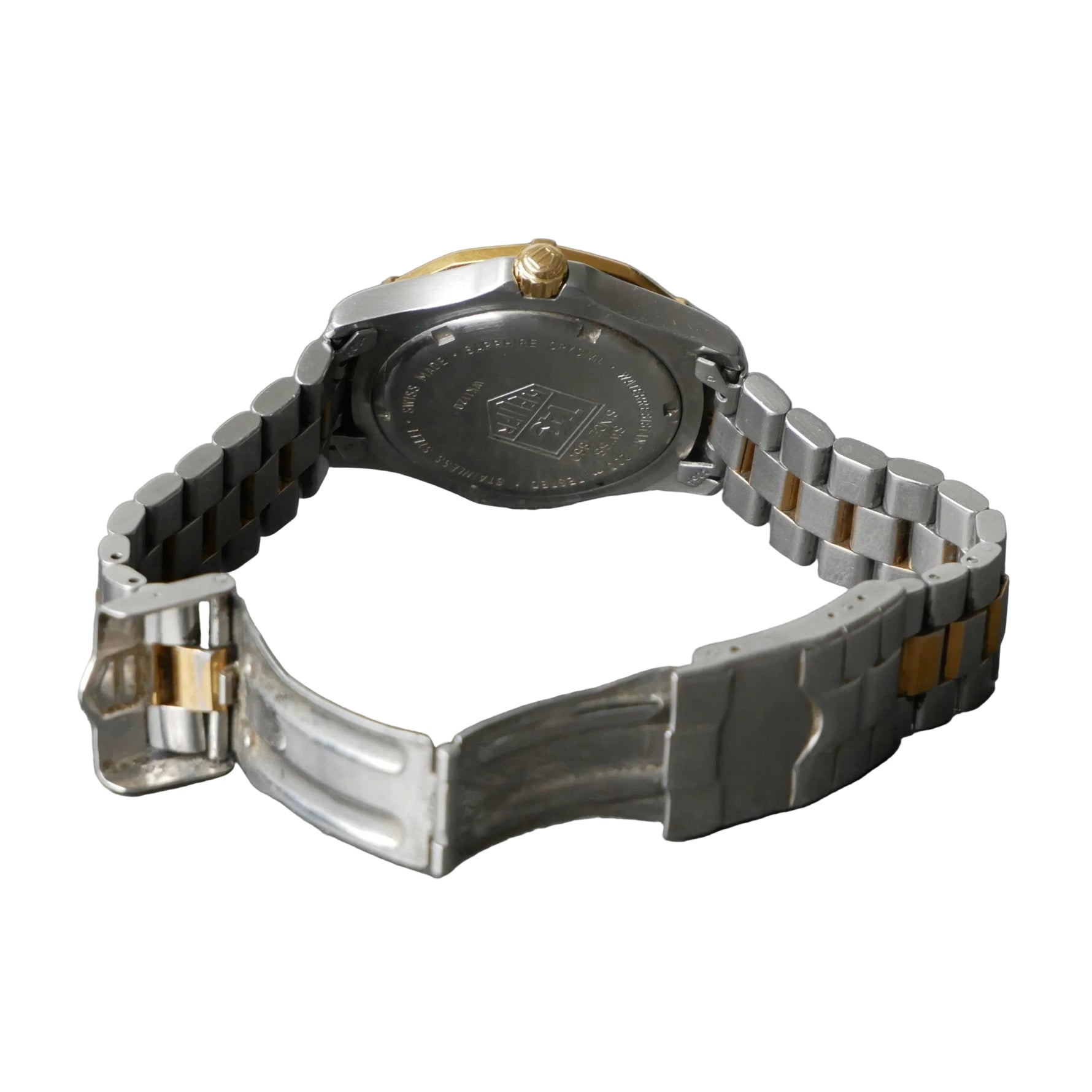 Close-up of a silver and black watch on a gray surface