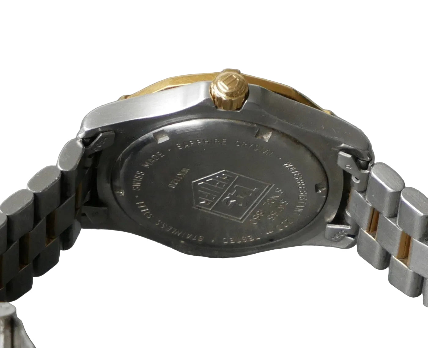 Close-up of a watch case with brand logo on a gray background