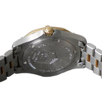 Close-up of a watch with a brand logo on a gray background