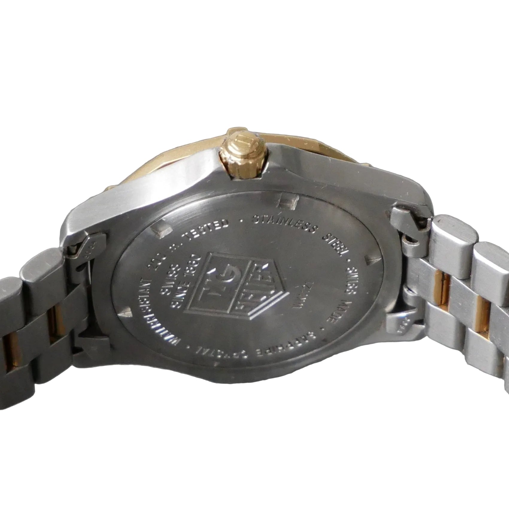 Close-up of a watch with a brand logo on a gray background
