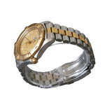 Gold and silver watch on a clear stand against a gray background