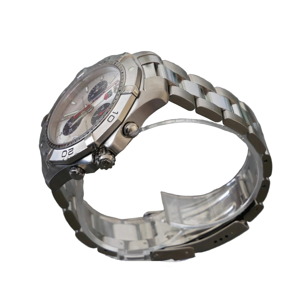 Silver watch on a clear stand with a gray background