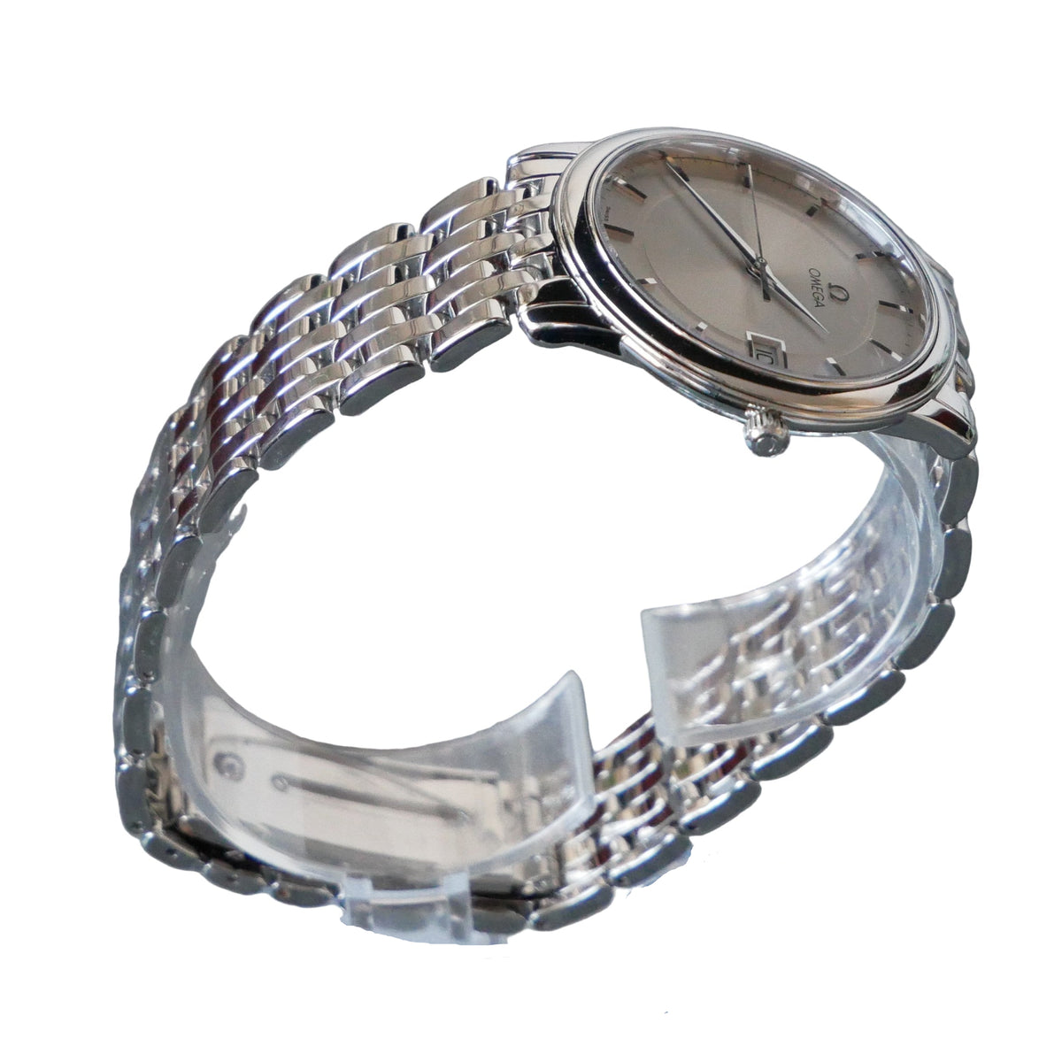 Silver wristwatch on a clear stand against a gray background