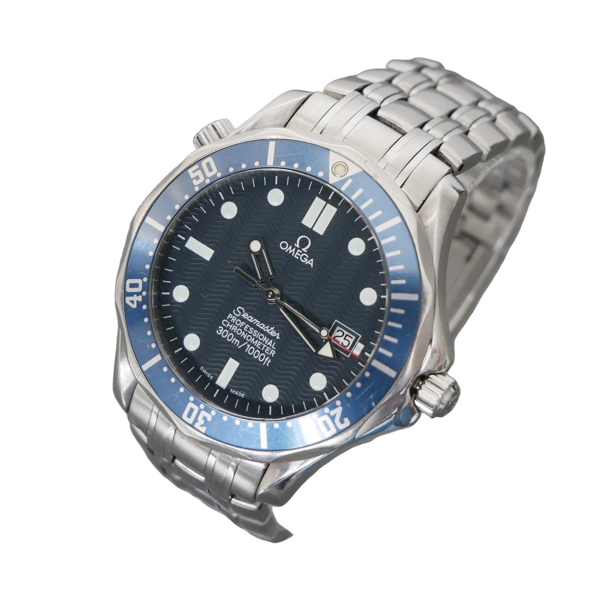 Omega Seamaster dive watch with a stainless steel link bracelet, featuring a blue dial, blue bezel, and silver case, displayed on a clear stand against a gray background.