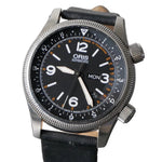 An Oris Automatic watch with a black dial, silver stainless steel case, and a black leather strap, shown close-up against a gray textured background.