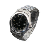 Silver Omega watch on a clear stand against a gray background