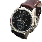 A Hamilton Jazzmaster Quartz Chronograph watch with a black dial, stainless steel case, and a brown leather bracelet.