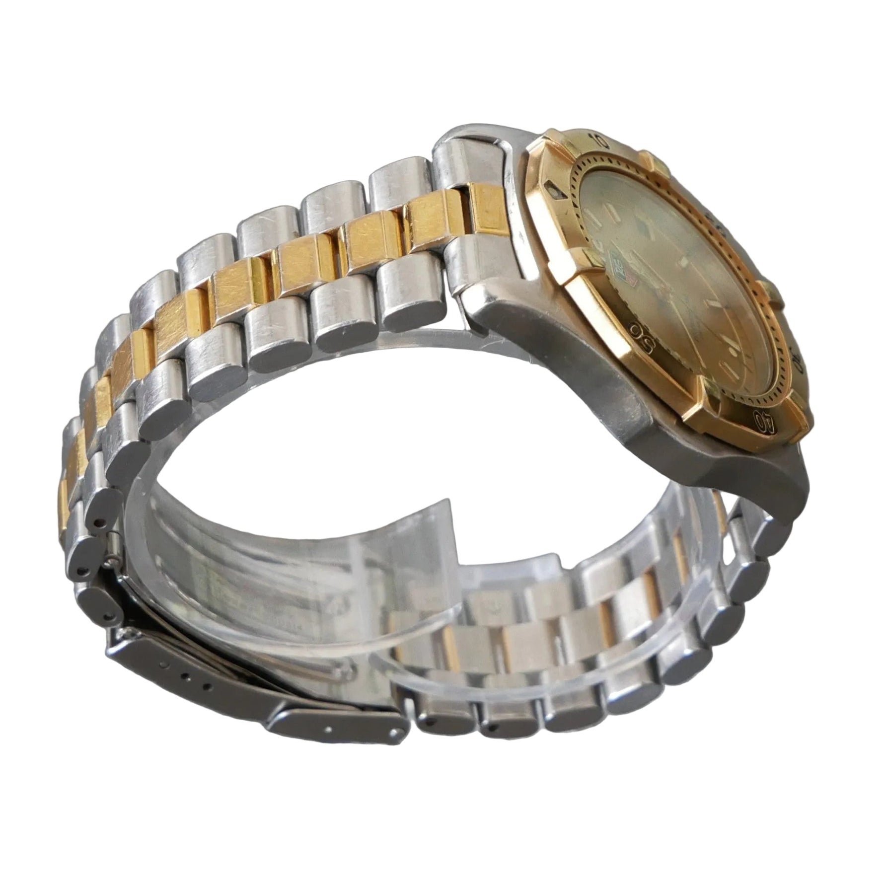 Two-tone silver and gold watch on a clear stand with a gray background