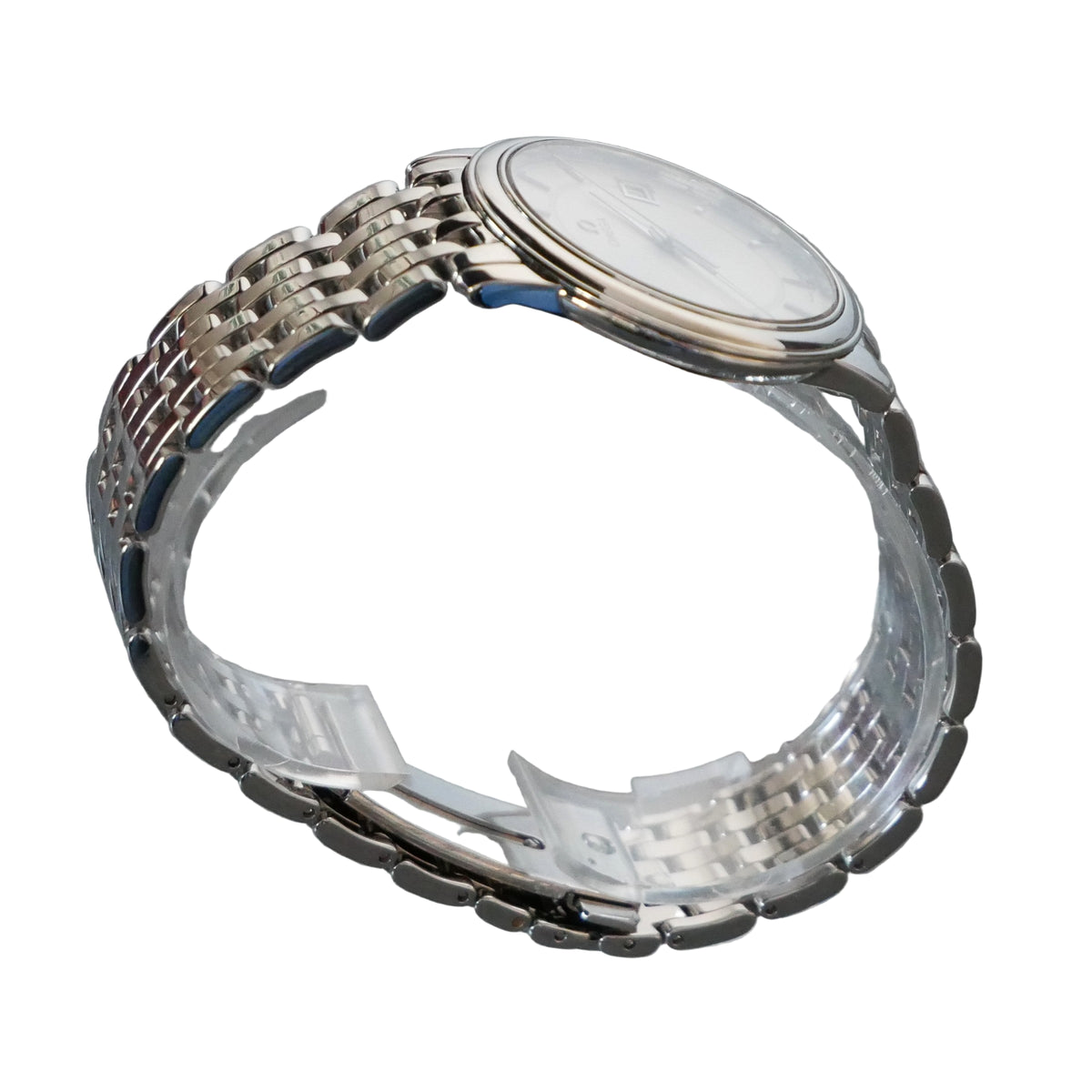 Silver watch on a clear stand with a gray background