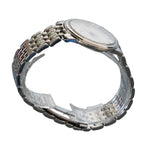 Silver watch on a clear stand with a gray background