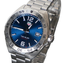 Load image into Gallery viewer, Silver watch with blue dial on a gray background
